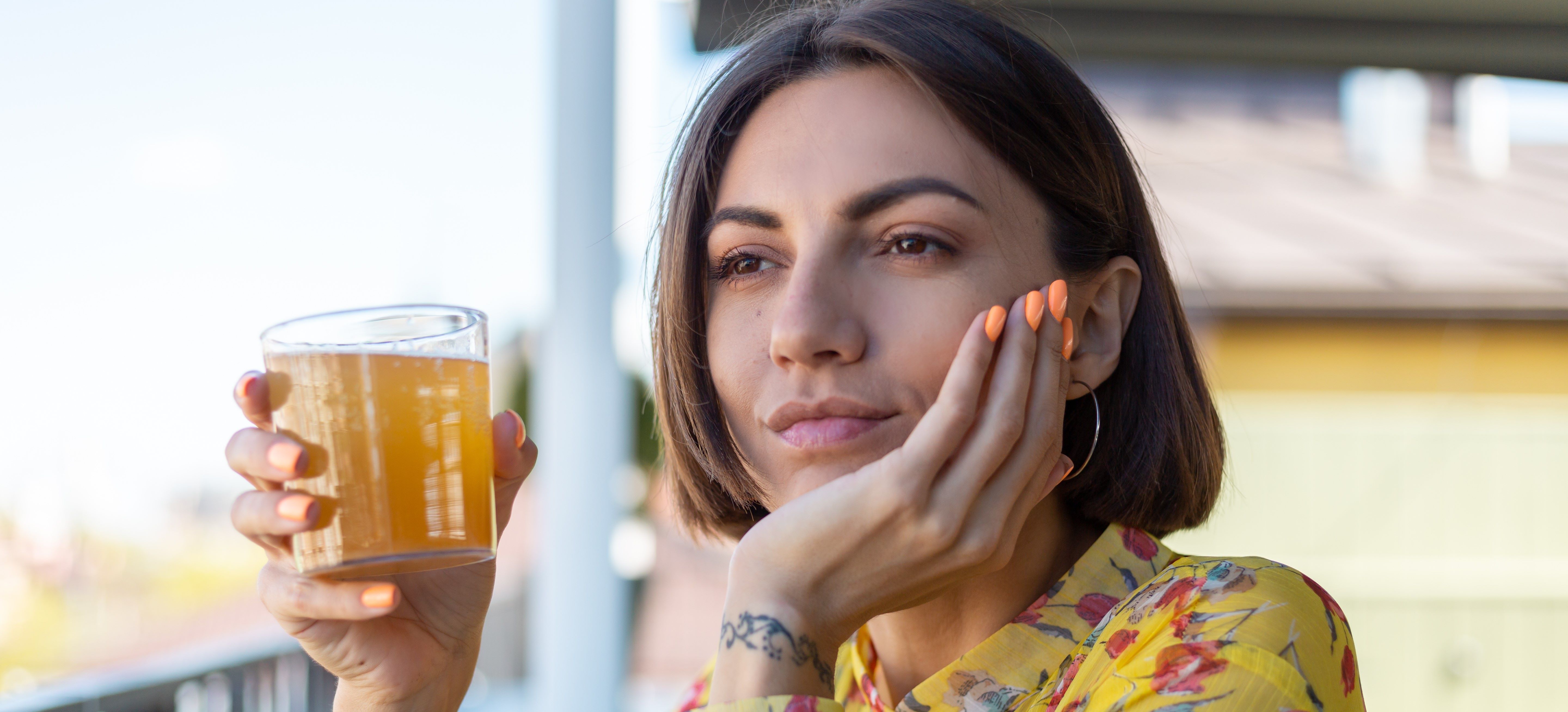 Woman drinking a gut health kombucha drink